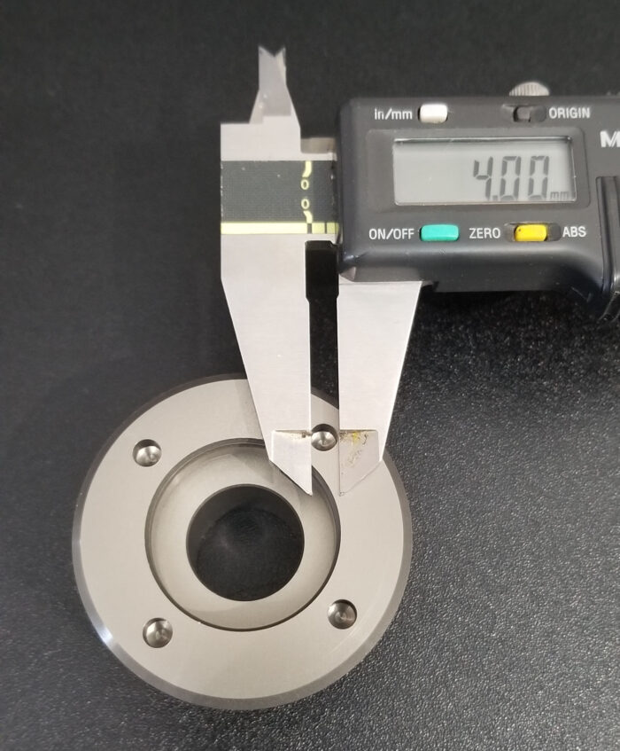 Caliper measuring metal component with 4.00 mm.