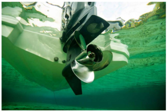 Boat motor propeller underwater in clear water.