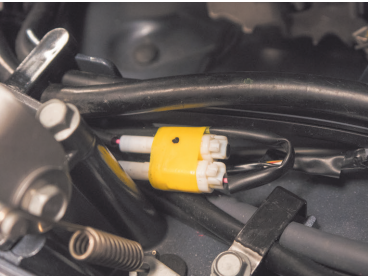 Wires and connector inside a vehicle engine.