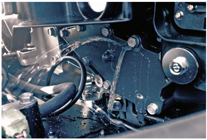 Close-up of machinery with liquid leakage.