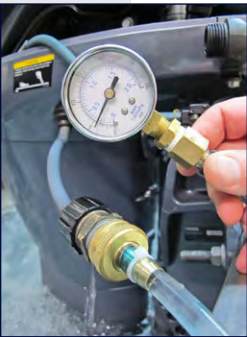 Pressure gauge connected to a hose and fitting.